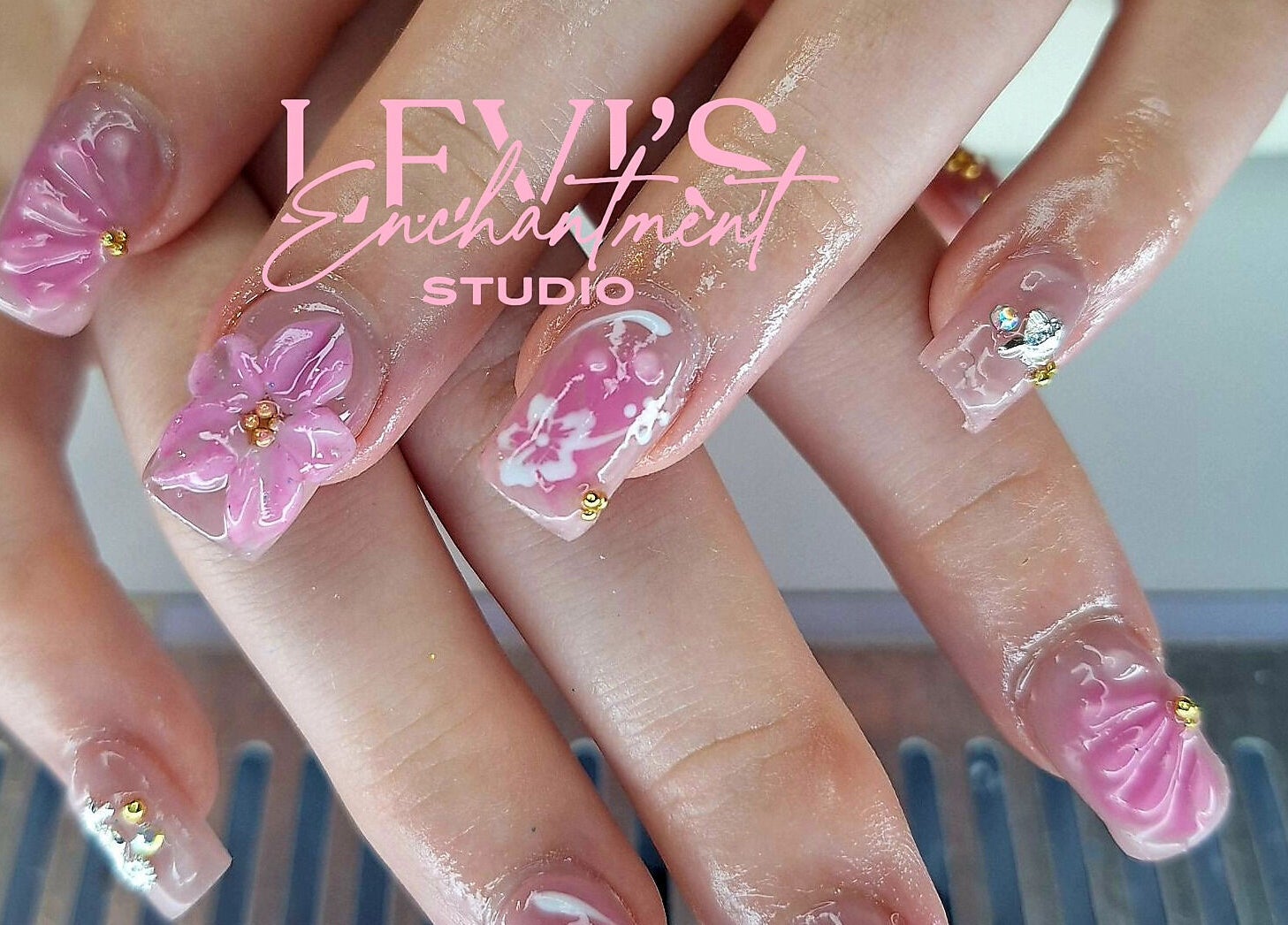Elegant pink floral nail art at Levi's Enchantment Studio, Torquay, England, GB.