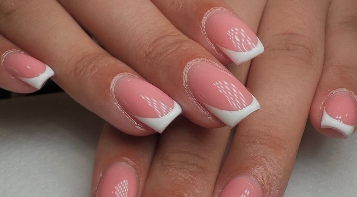 Stylish French manicure at Georgialees Beauty, Solihull, England, GB showcasing pink nails with white tips.
