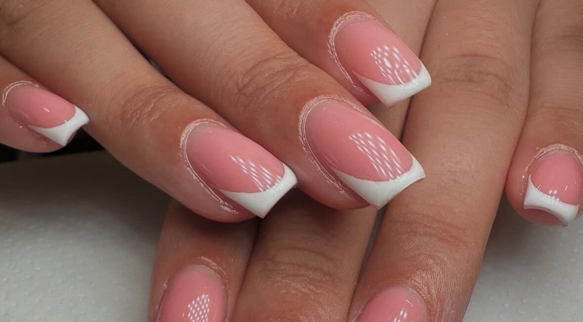 Stylish French manicure at Georgialees Beauty, Solihull, England, GB showcasing pink nails with white tips.