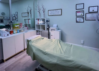 Inviting treatment room at The Lotus Chair, LLC in Boca Raton, Florida, US with certificates and equipment.