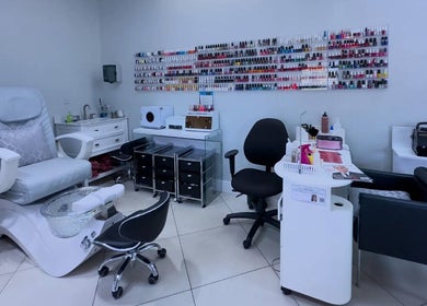 Spacious nail salon at The Lotus Chair, LLC, Boca Raton, Florida, US featuring modern pedicure chairs and nail polish display.