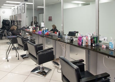 Modern salon interior at The Lotus Chair, LLC in Boca Raton, Florida, US with elegant styling stations.