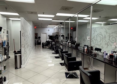 Chic, modern interior of The Lotus Chair salon in Boca Raton, Florida, US with sleek styling stations.