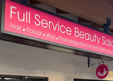 The Lotus Chair sign in Boca Raton, Florida offers full beauty services including hair, facials, and more.