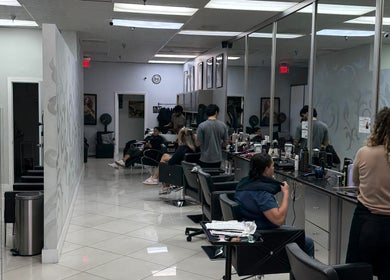 Stylish interior of The Lotus Chair salon in Boca Raton, Florida, US with clients and stylists.