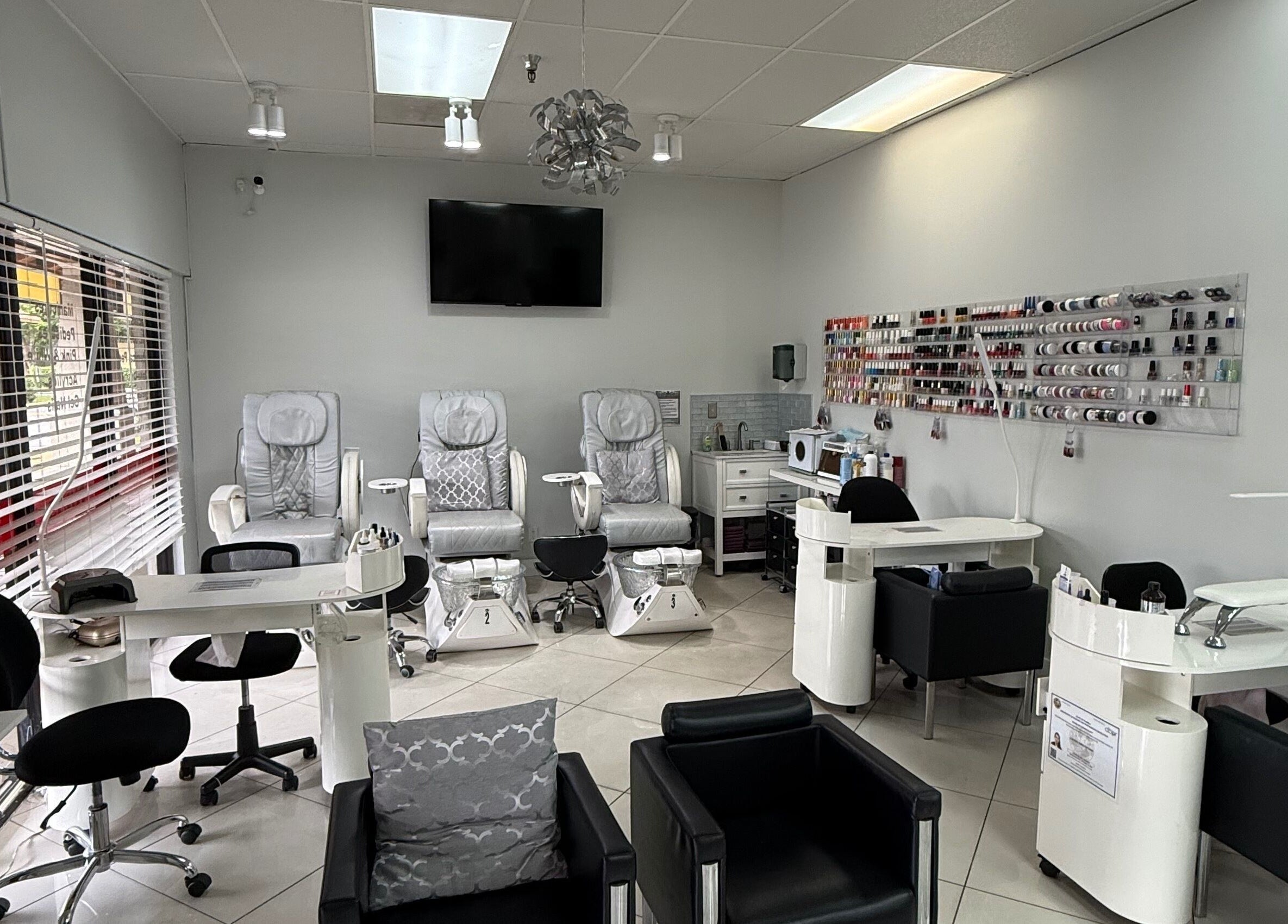 Elegant nail salon at The Lotus Chair in Boca Raton, Florida, US with plush chairs and nail polish display.