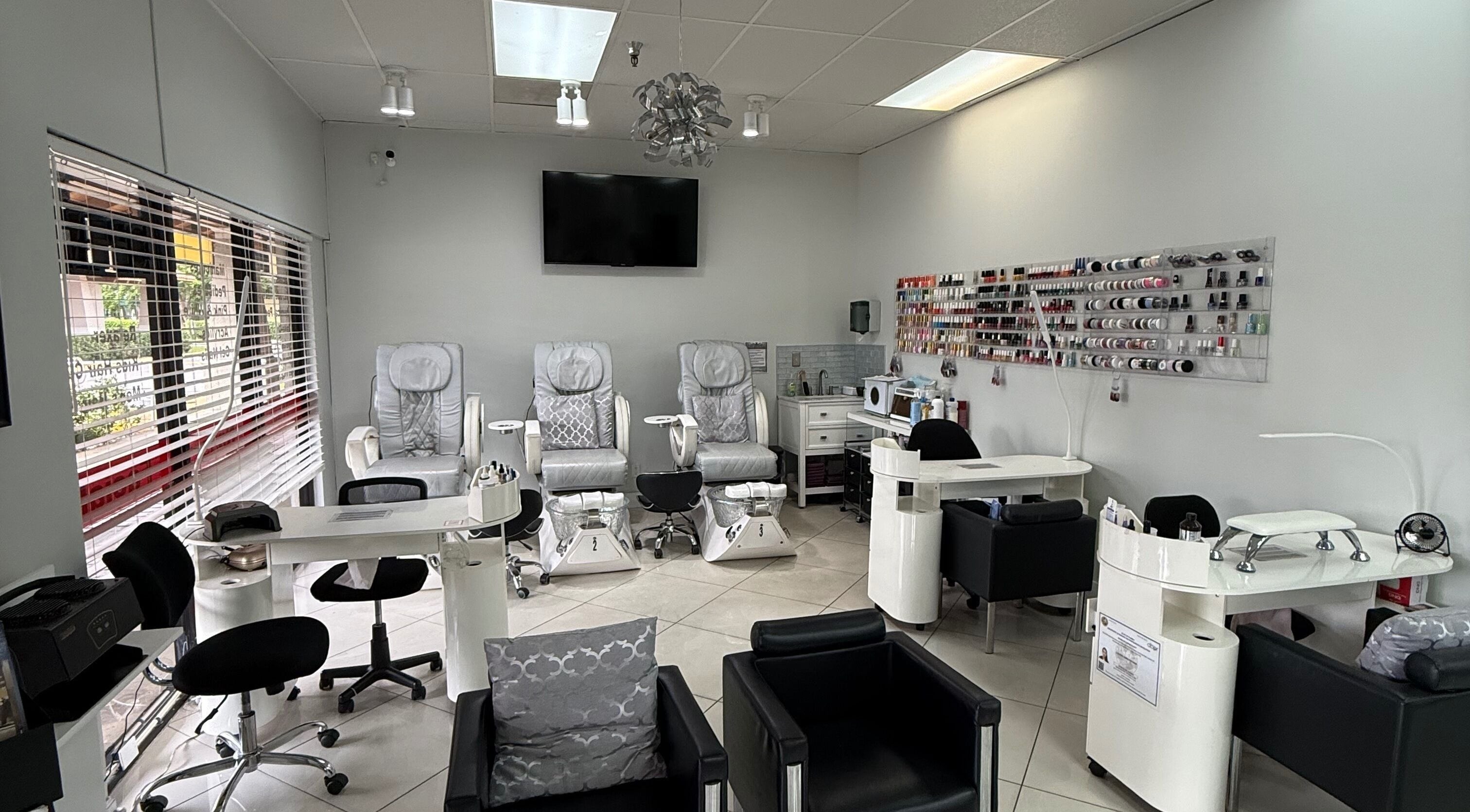 Elegant nail salon at The Lotus Chair in Boca Raton, Florida, US with plush chairs and nail polish display.