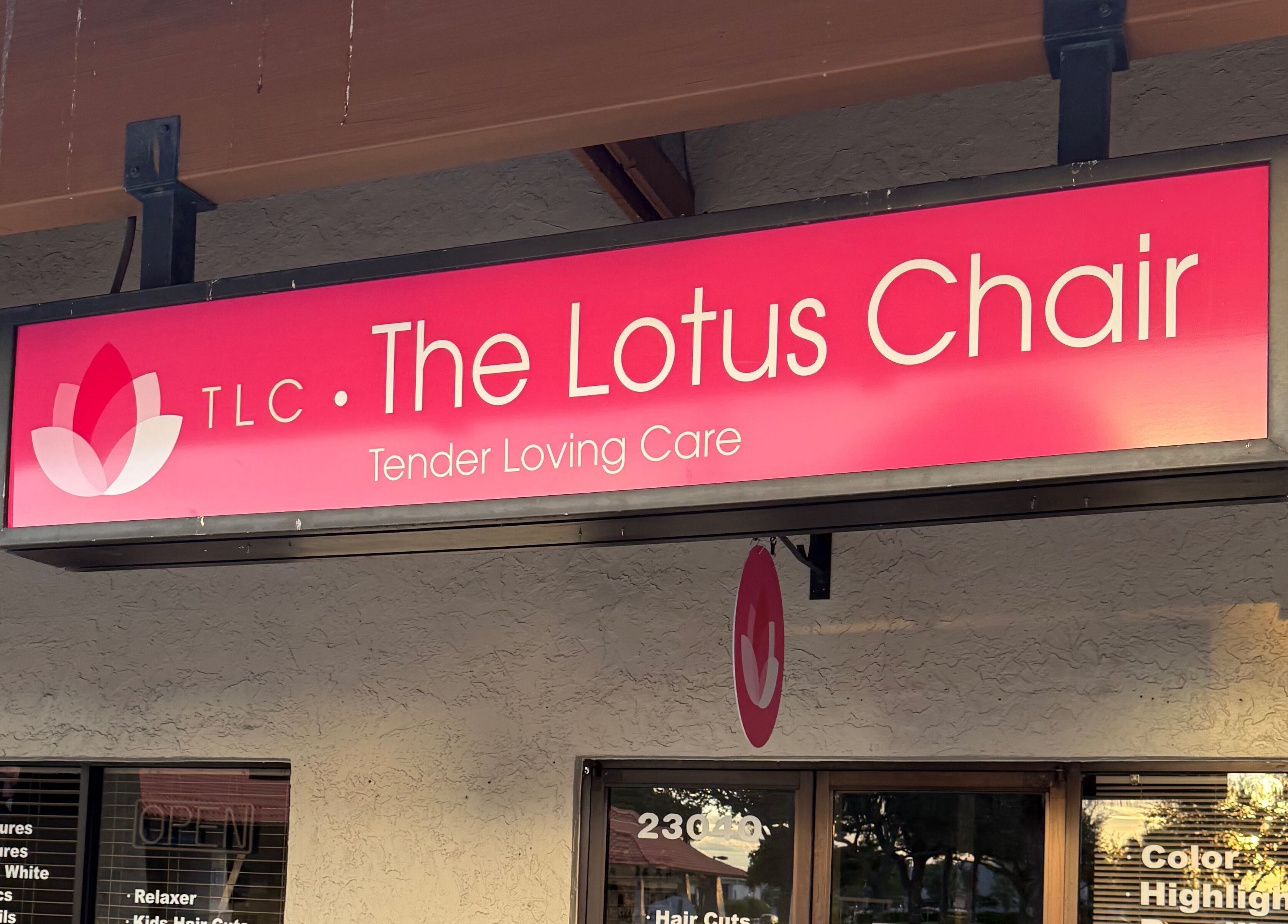 Exterior sign of The Lotus Chair in Boca Raton, Florida, US showcasing beauty services.