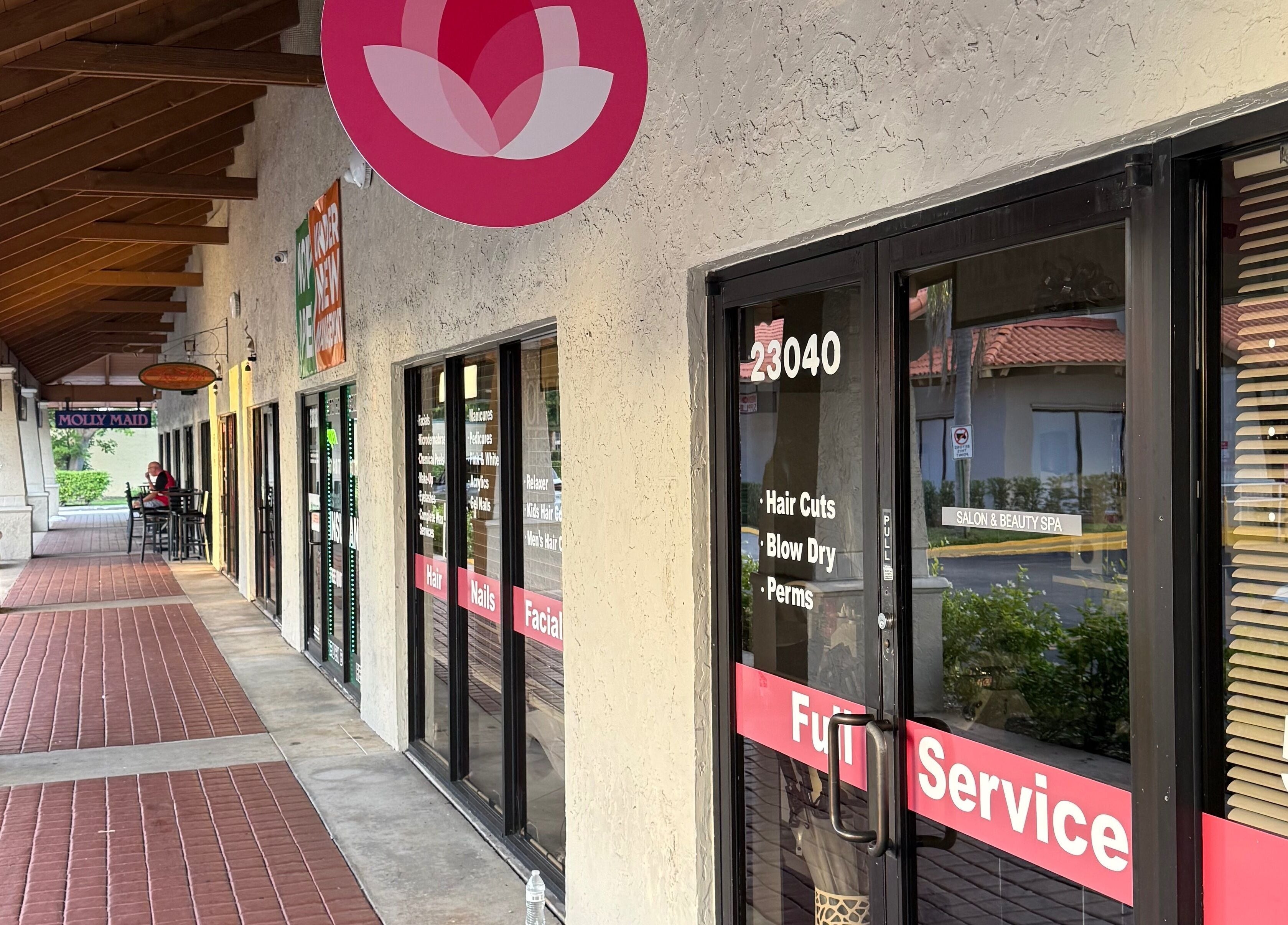 Entrance to The Lotus Chair salon in Boca Raton, Florida, US showcasing inviting exterior design.