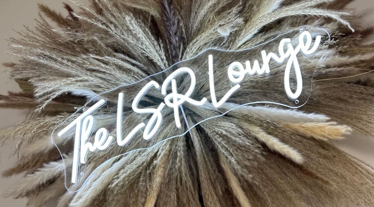 Neon sign reading 'The LSR Lounge' with pampas grass at LSR Lounge, Windlesham, England, GB.