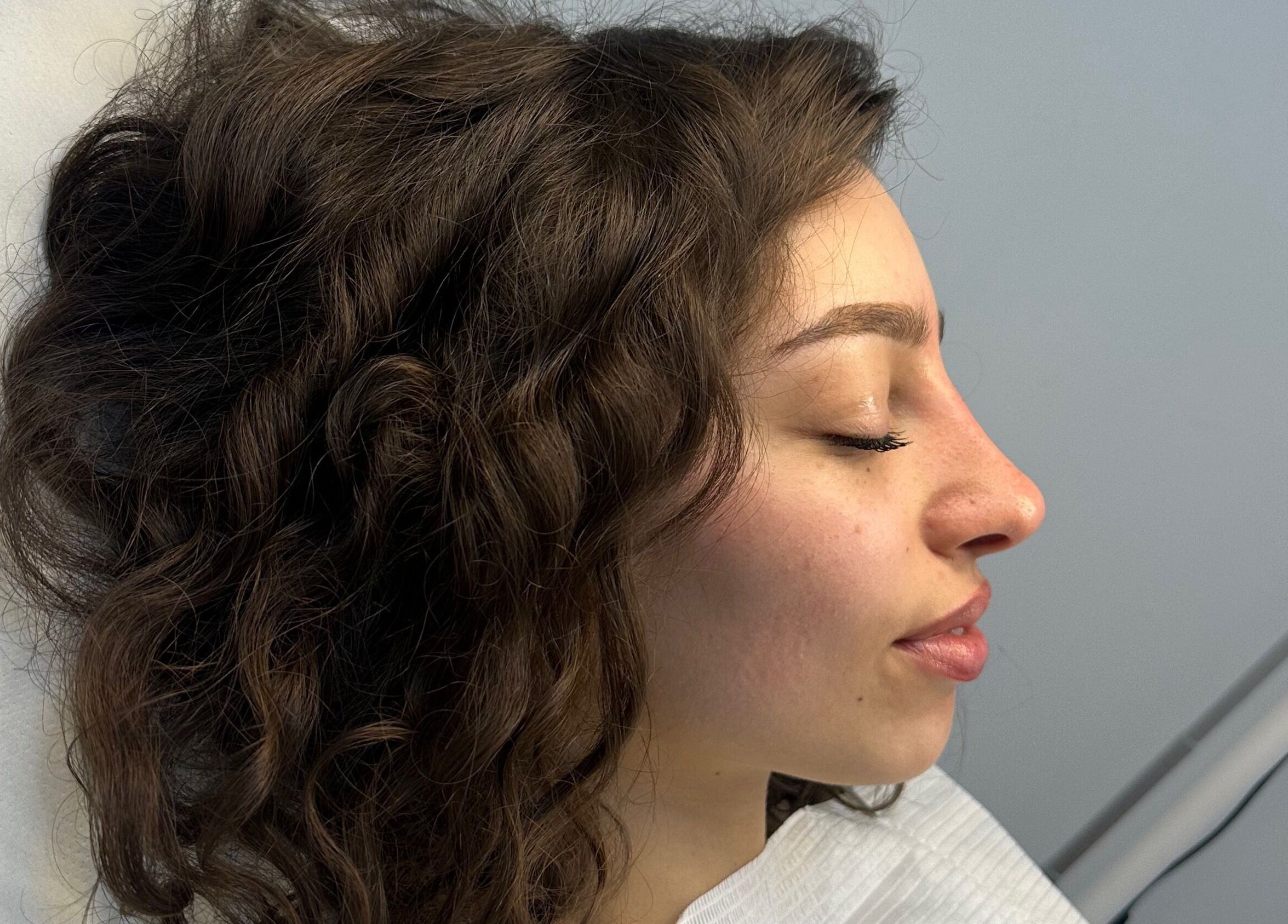 Relaxed client enjoying a skincare treatment at Amavi Aesthetics, Kingston Upon Thames, England, GB.