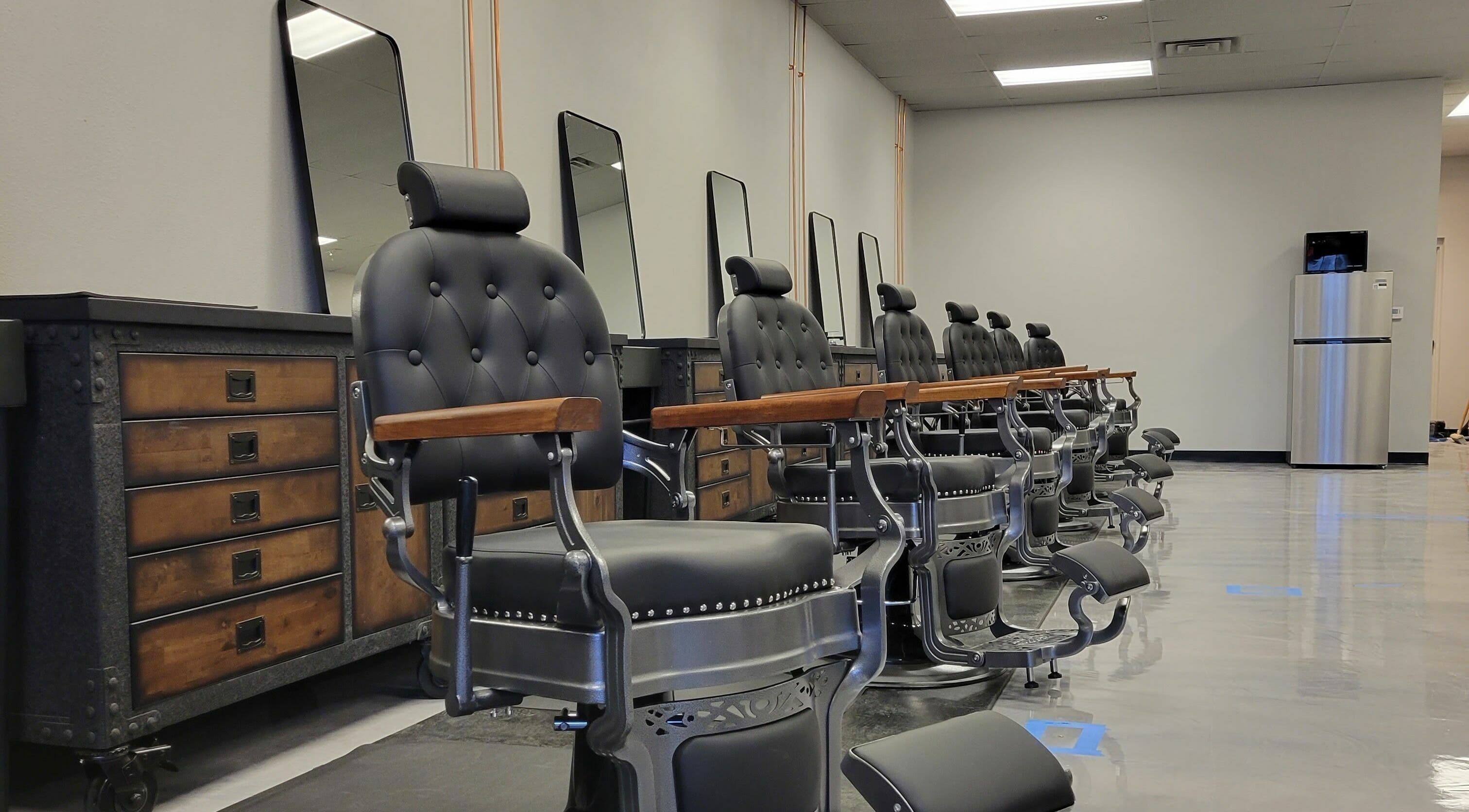Elegant barber chairs at Executive Men's Grooming Mesa in Mesa, Arizona, US, showcasing sleek design.