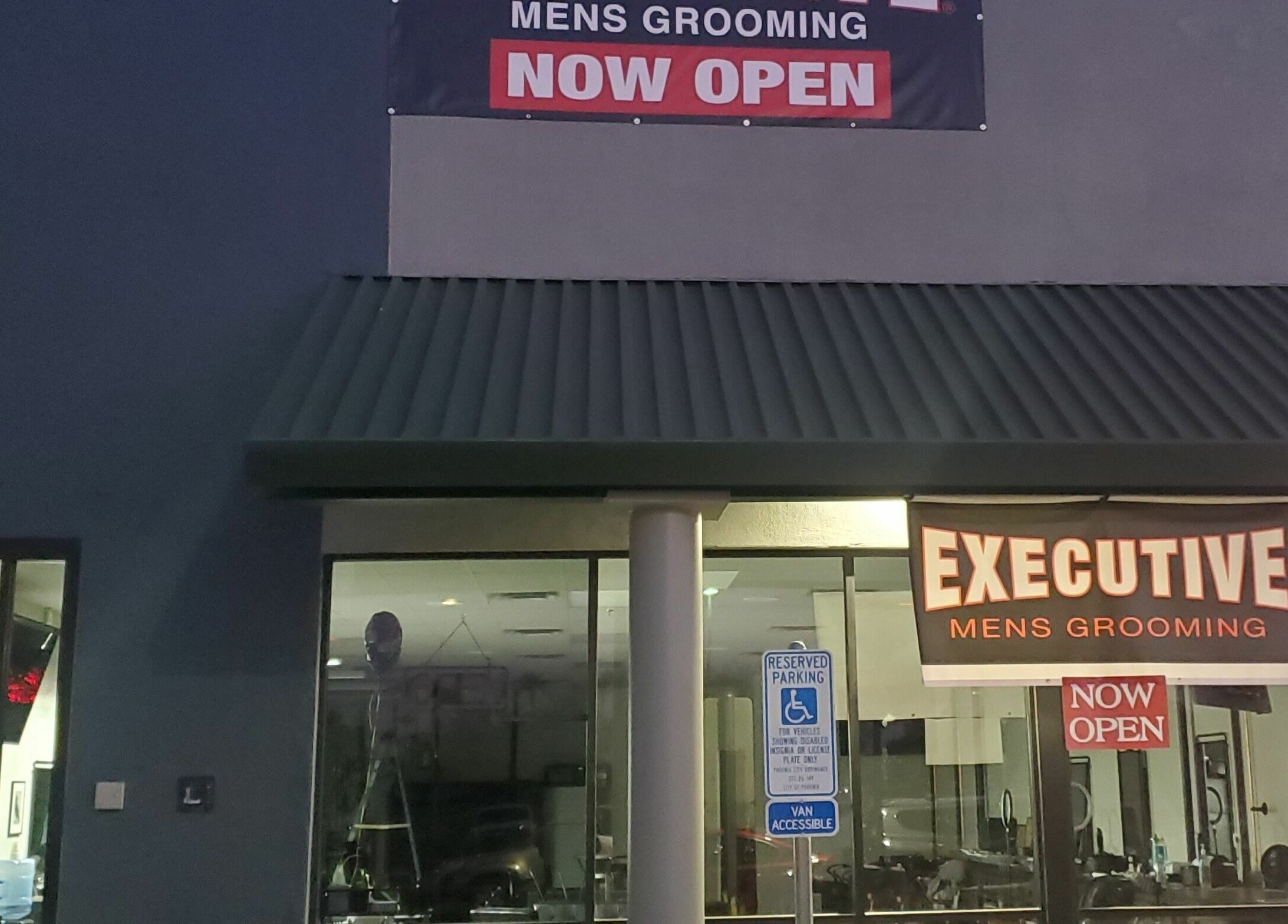 Exterior of Executive Men's Grooming Mesa in Mesa, Arizona, US, with prominent signage showing 'Now Open'.