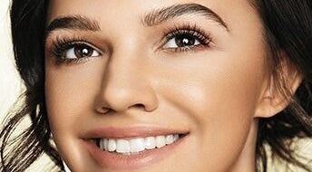 Close-up of a woman's radiant smile and lashes at Lash Ink, Rugby, England, GB.