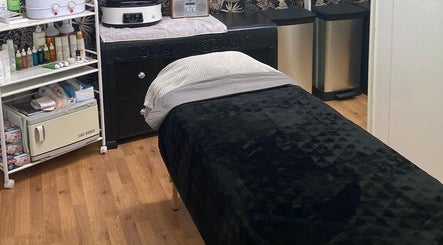 Relaxing treatment room at The Soul Sanctuary, Little Brickhill, England, GB, featuring massage bed and supplies.