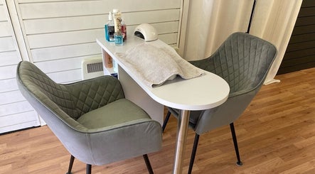 A cozy nail salon setup at The Soul Sanctuary in Little Brickhill, England, GB with plush chairs and manicure table.