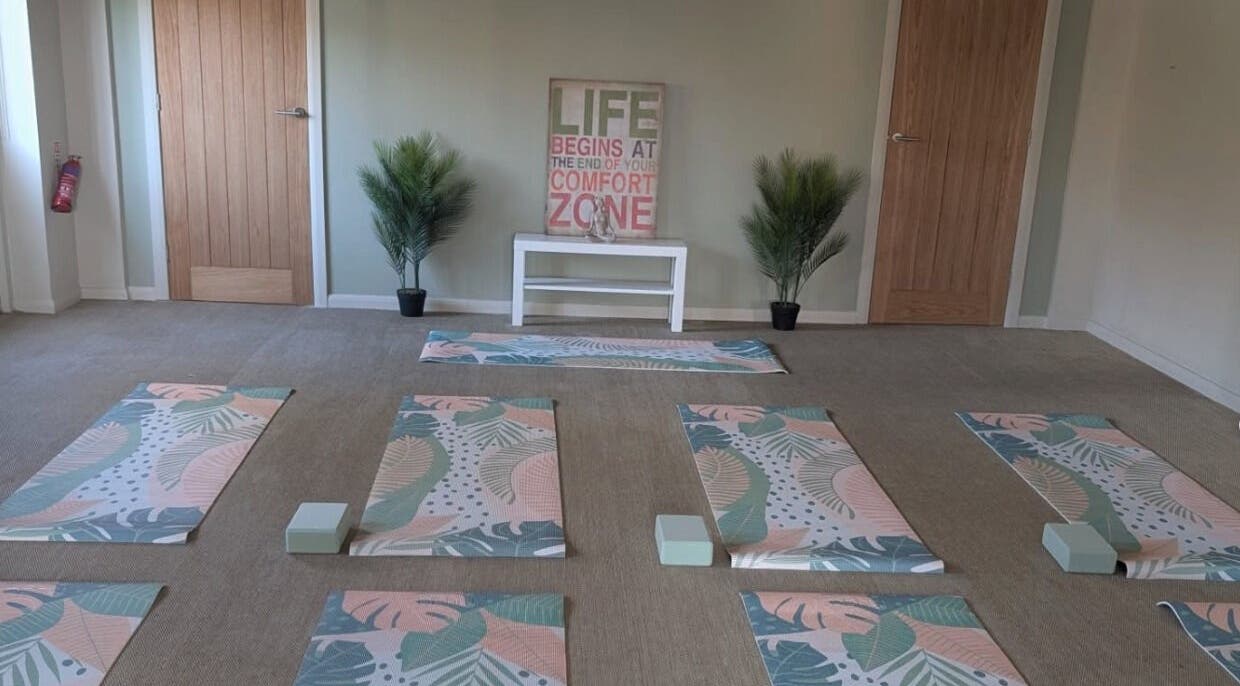 Tranquil yoga room at Purple Lotus Acupuncture in Hockerton, England, GB with mats and calming decor.