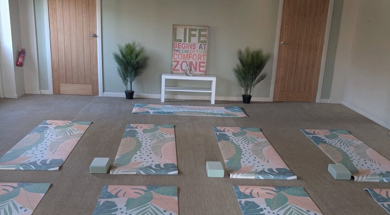 Tranquil yoga room at Purple Lotus Acupuncture in Hockerton, England, GB with mats and calming decor.