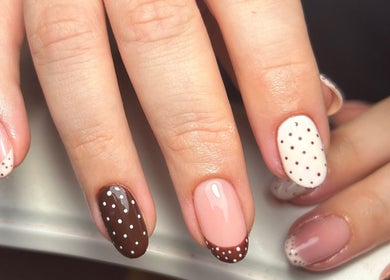 Polka dot nail art at Beauty in the Peak, High Peak, England, GB. Perfect blend of elegance and style.