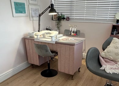 Elegant nail station at Beauty in the Peak, High Peak, England, GB, with cozy chairs and vibrant decor.
