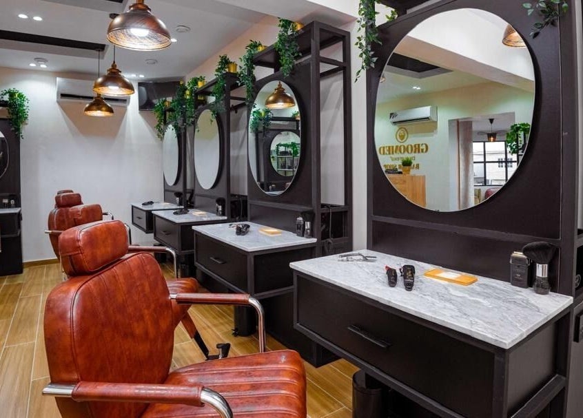 Modern salon setup at Groomed By Elereka Lekki with stylish mirrors and leather chairs in Lekki, Lagos, NG.