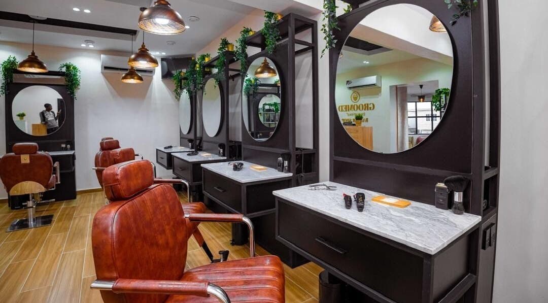 Modern salon setup at Groomed By Elereka Lekki with stylish mirrors and leather chairs in Lekki, Lagos, NG.