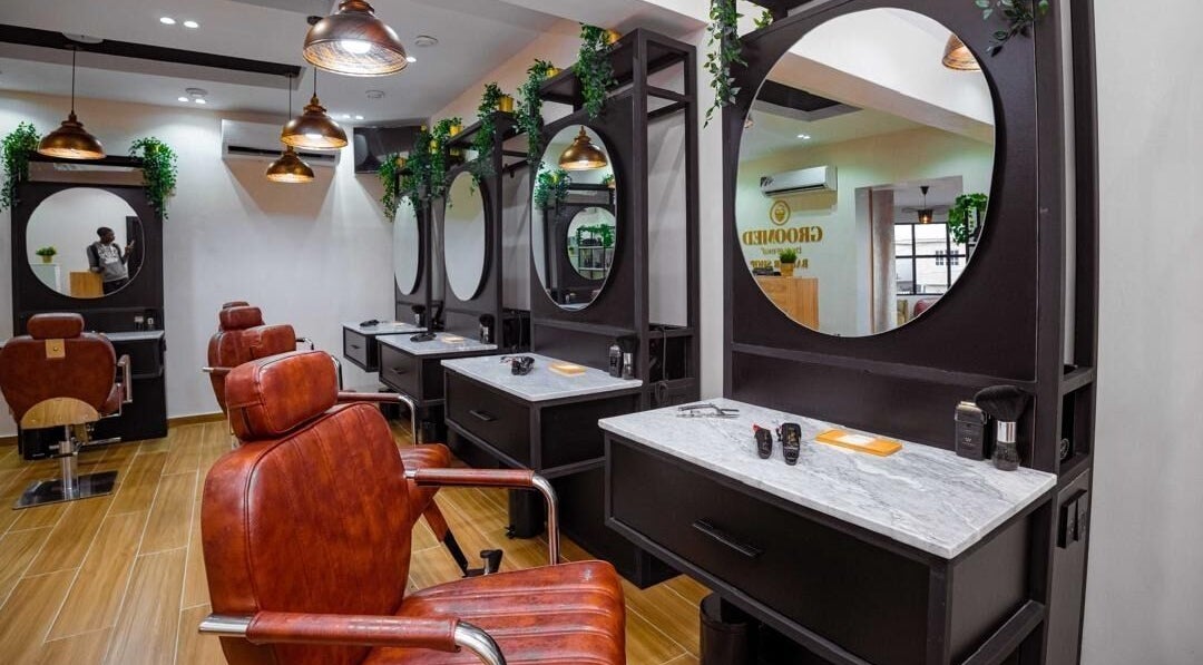 Modern salon setup at Groomed By Elereka Lekki with stylish mirrors and leather chairs in Lekki, Lagos, NG.
