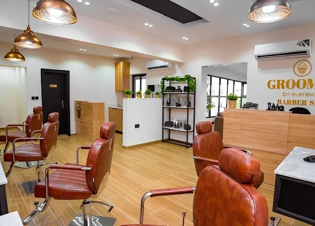 Interior of Groomed By Elereka Lekki, modern barber shop in Lekki, Lagos, NG with stylish chairs and decor.