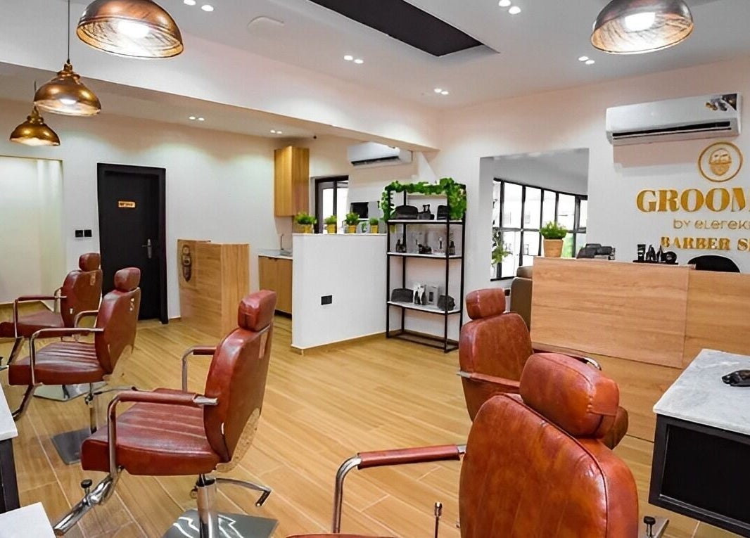 Interior of Groomed By Elereka Lekki, modern barber shop in Lekki, Lagos, NG with stylish chairs and decor.
