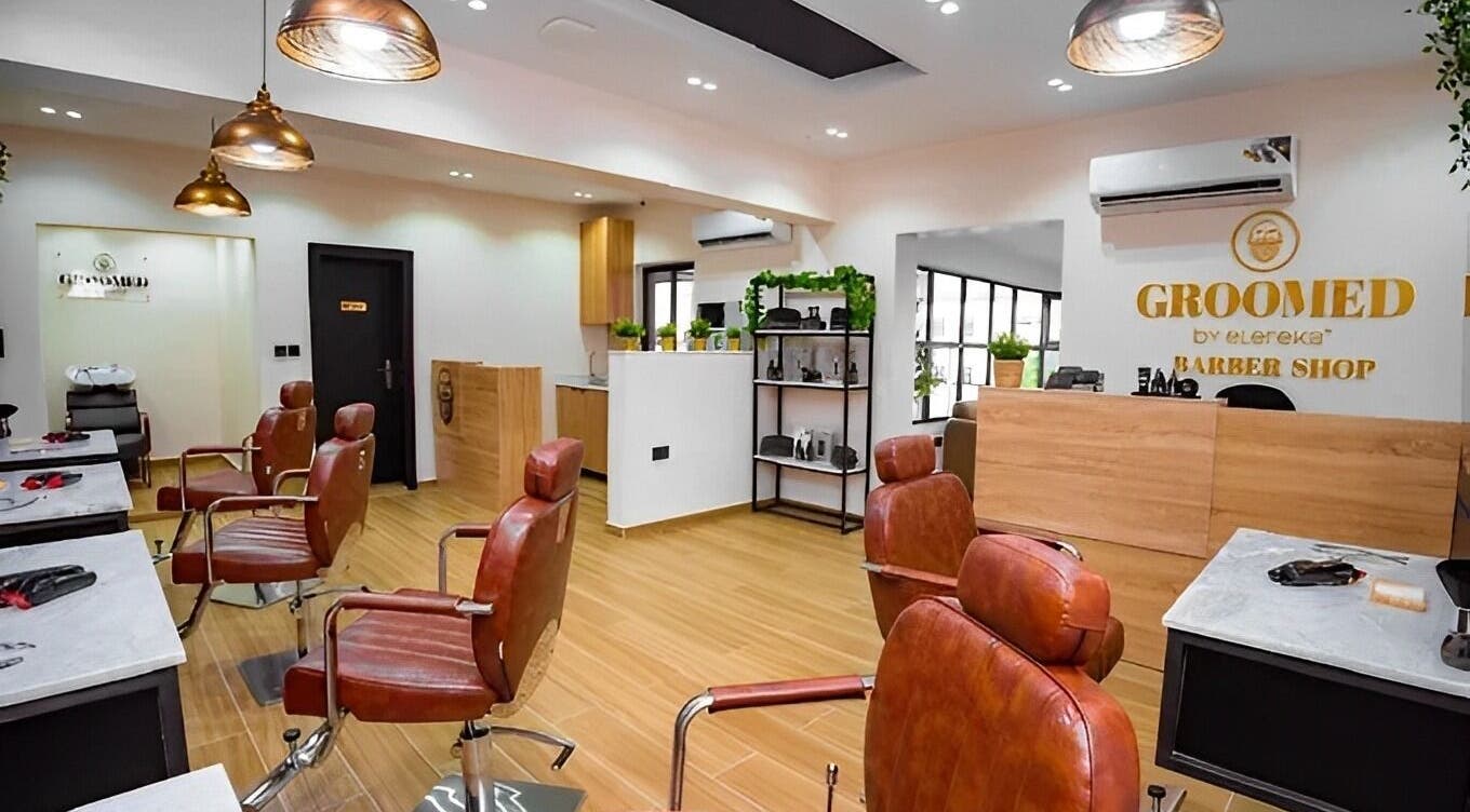 Interior of Groomed By Elereka Lekki, modern barber shop in Lekki, Lagos, NG with stylish chairs and decor.