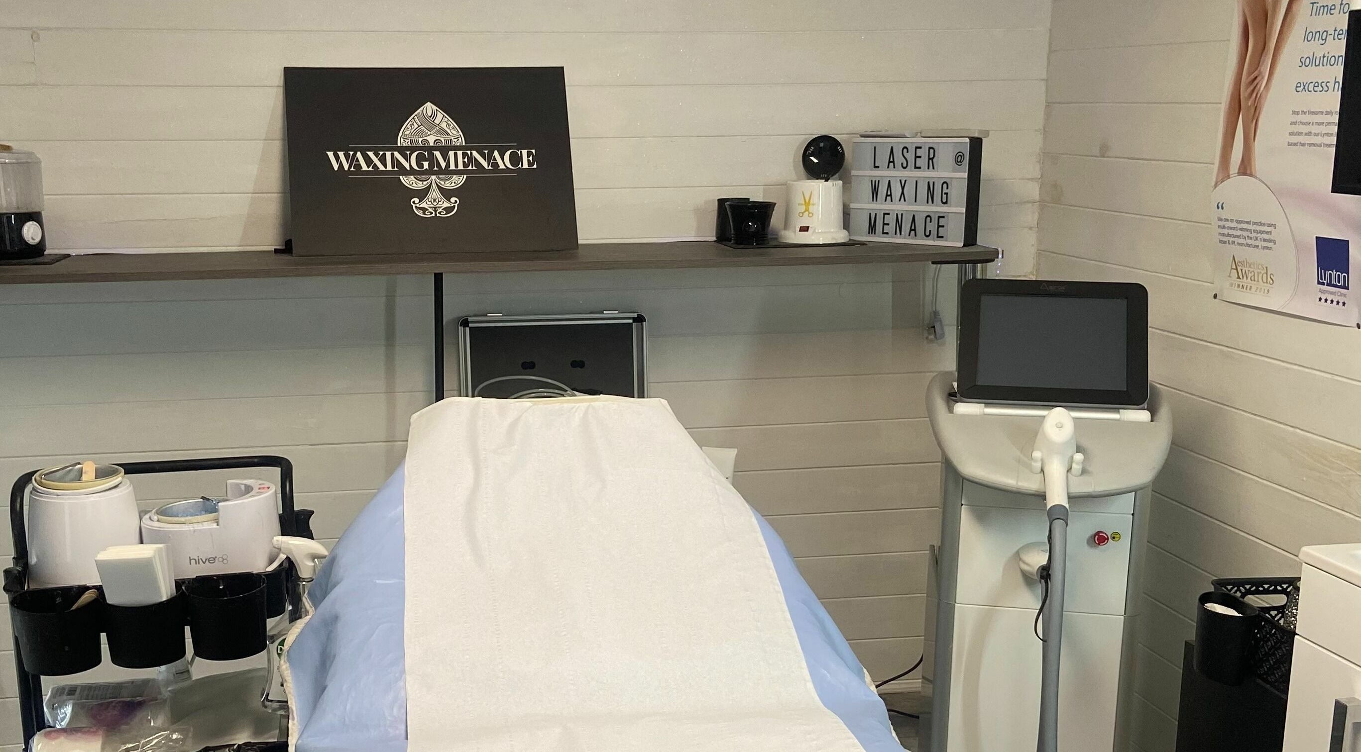 Modern waxing and laser setup at The Waxing Menace in Stevenage, England, GB showcasing equipment and treatment bed.