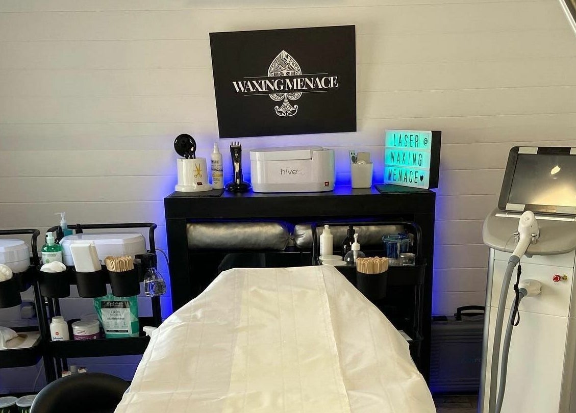 Modern treatment room at The Waxing Menace, Stevenage, England, GB, featuring sleek equipment and decor.