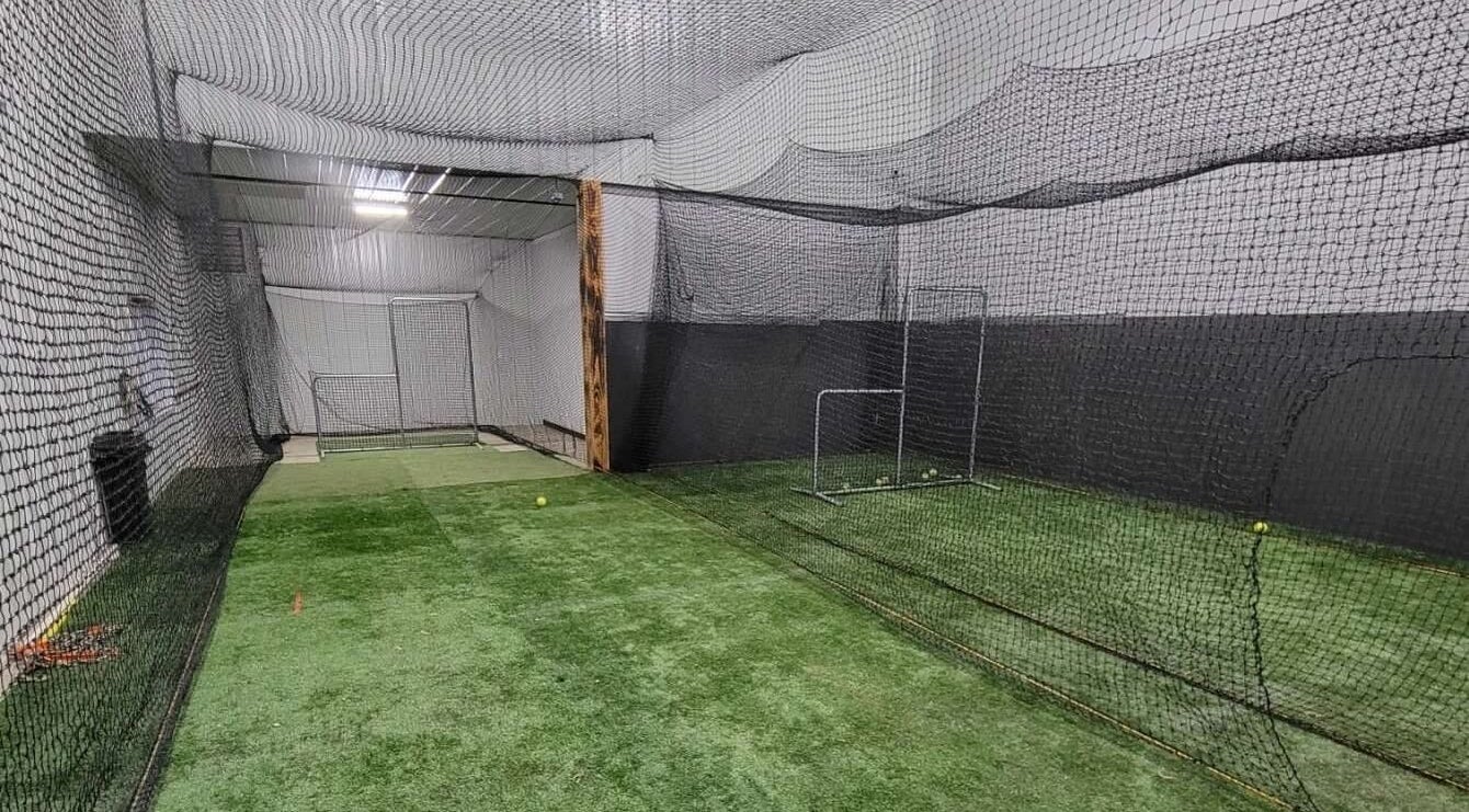 Spacious indoor practice nets at House of Hits, Altoona, Pennsylvania, US, ideal for sports enthusiasts.