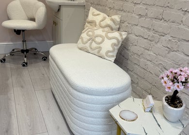 Elegant seating area at Redefine Body Contouring, Poynton, Cheshire, England, GB with chic white decor.