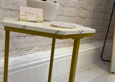Modern table with Redefine Body Contouring card at their Poynton, Cheshire, England, GB venue.