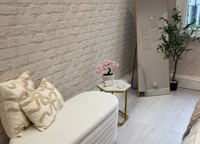 Relaxing space at Redefine Body Contouring, Poynton, Cheshire, England, GB; with soft seating and decor.