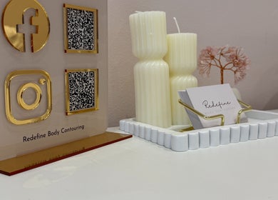 Elegant display at Redefine Body Contouring, Poynton, Cheshire, England featuring candles and QR codes.