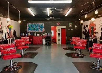 Stylish salon interior with red chairs at Pampered by Anie, Yukon, Oklahoma, US.