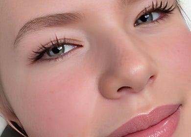 Close-up of a serene face showcasing flawless skin at Pampered by Anie, Yukon, Oklahoma, US.
