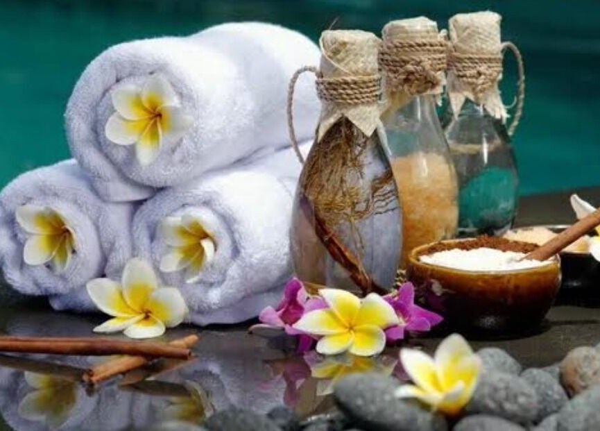 Relaxing spa setup with towels, flowers, and oils at Mica Spa Wellness, Vaughan, Ontario, CA.