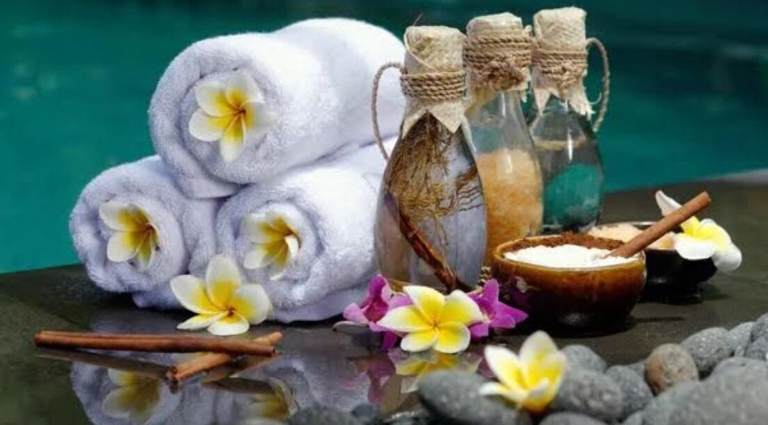 Relaxing spa setup with towels, flowers, and oils at Mica Spa Wellness, Vaughan, Ontario, CA.
