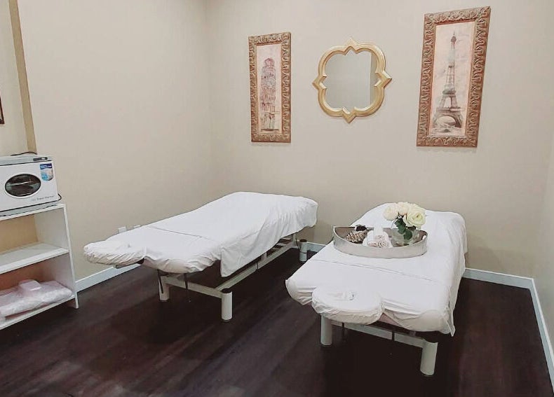 Relaxing treatment room at Mica Spa Wellness, Vaughan, Ontario, CA, featuring massage beds and elegant decor.