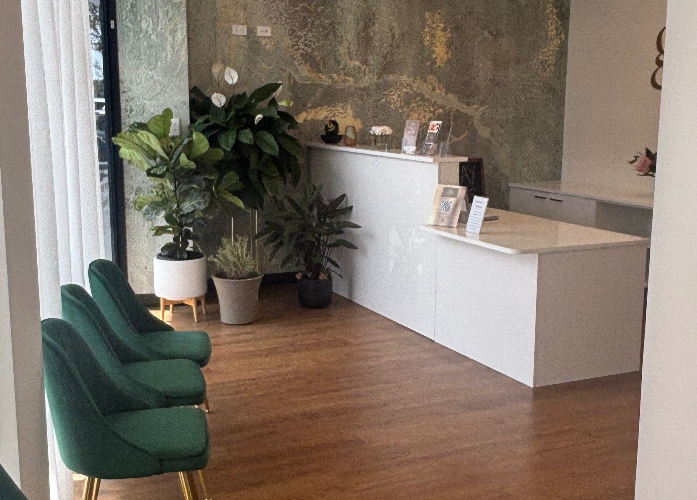 Elegant seating area at The Retreat Room At Glo Medispa, Grantham Farm, NSW, with vibrant plants and modern decor.