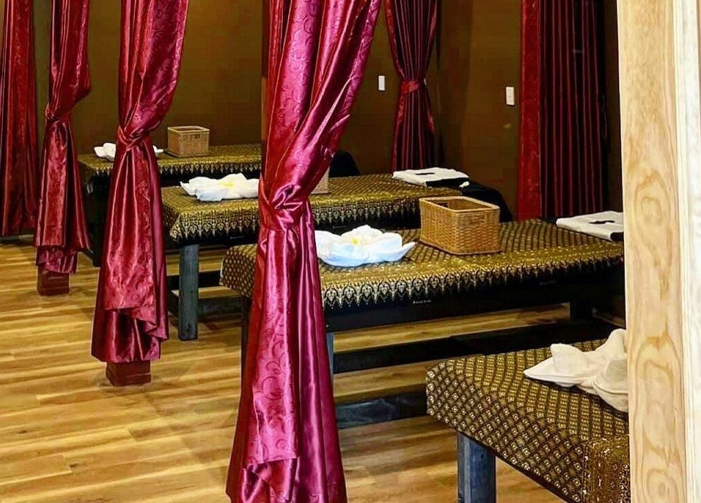 Relaxing spa beds with red curtains at Thai Chada Massage and Spa, Mascot, New South Wales, AU.