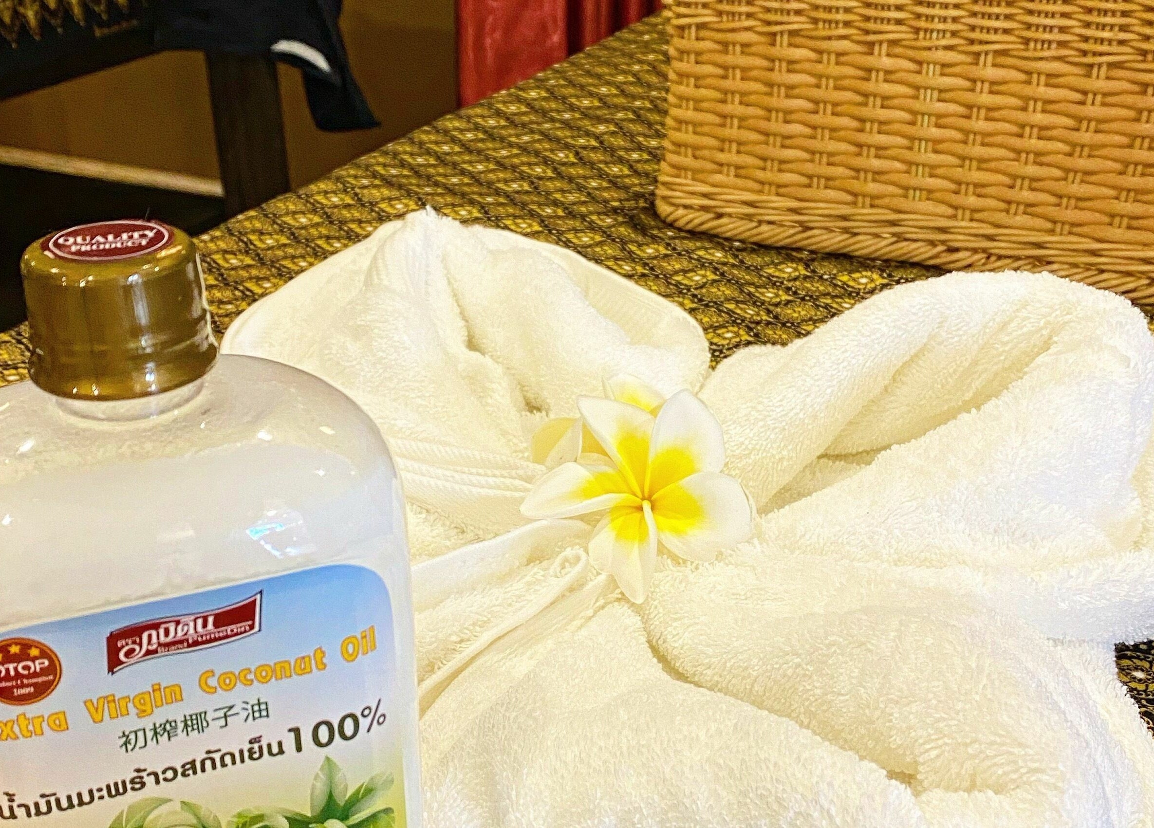 Coconut oil and towels with flower adornment at Thai Chada Massage and Spa, Mascot, New South Wales, AU.
