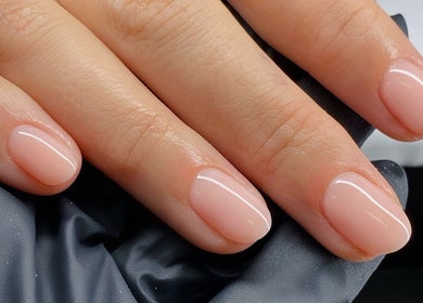 Elegant nude manicure at Melly's Beauty Parlour in Newstead, Queensland, AU, showcasing polished nails.