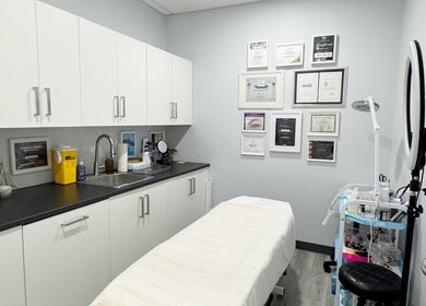 Professional treatment room at JM Permanent Makeup in Edmonton, Alberta, CA showcasing tools and certificates.