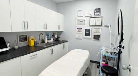Professional treatment room at JM Permanent Makeup in Edmonton, Alberta, CA showcasing tools and certificates.