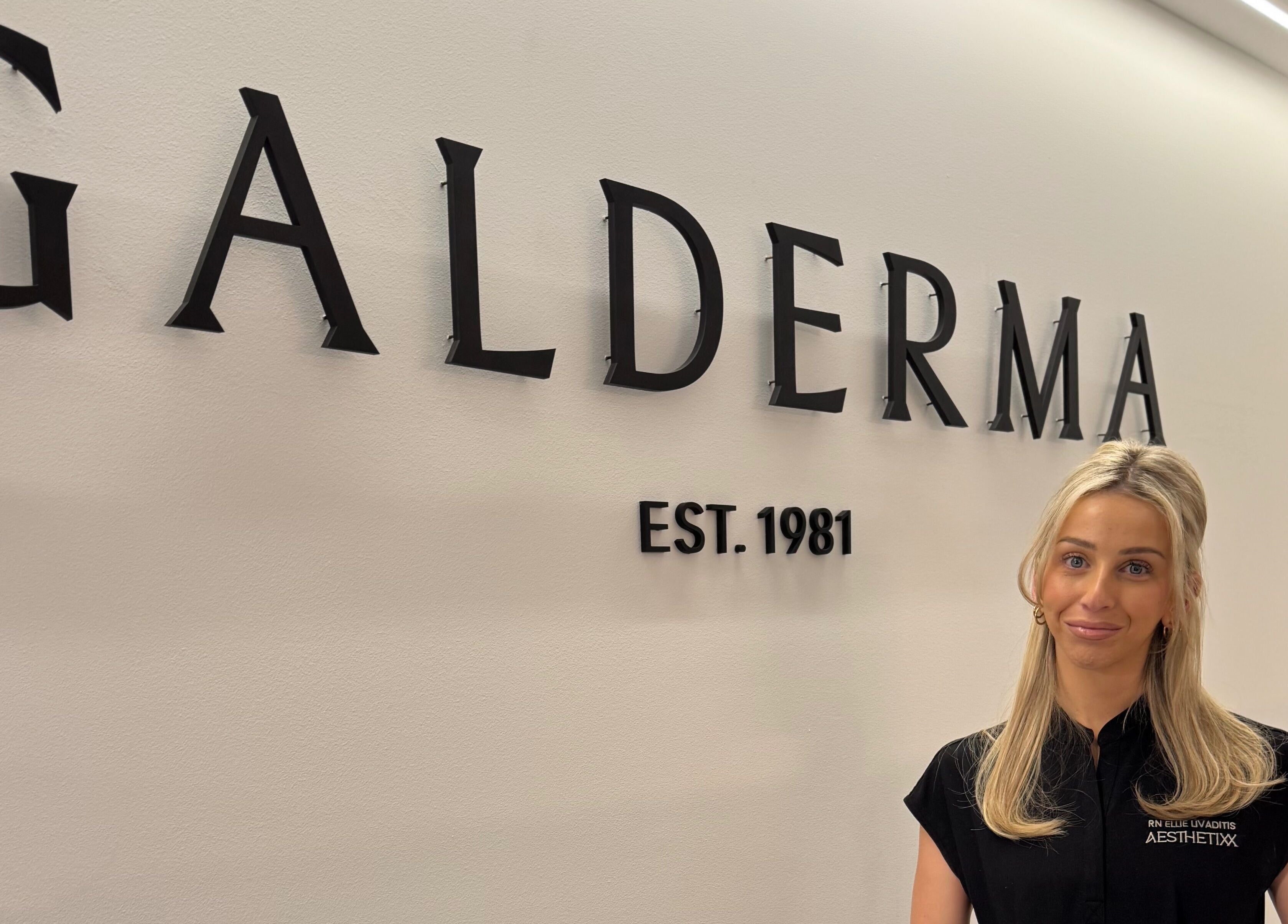 Elegant reception wall at Aesthetixx, Coburg North, Victoria, AU, featuring prominent Galderma signage.