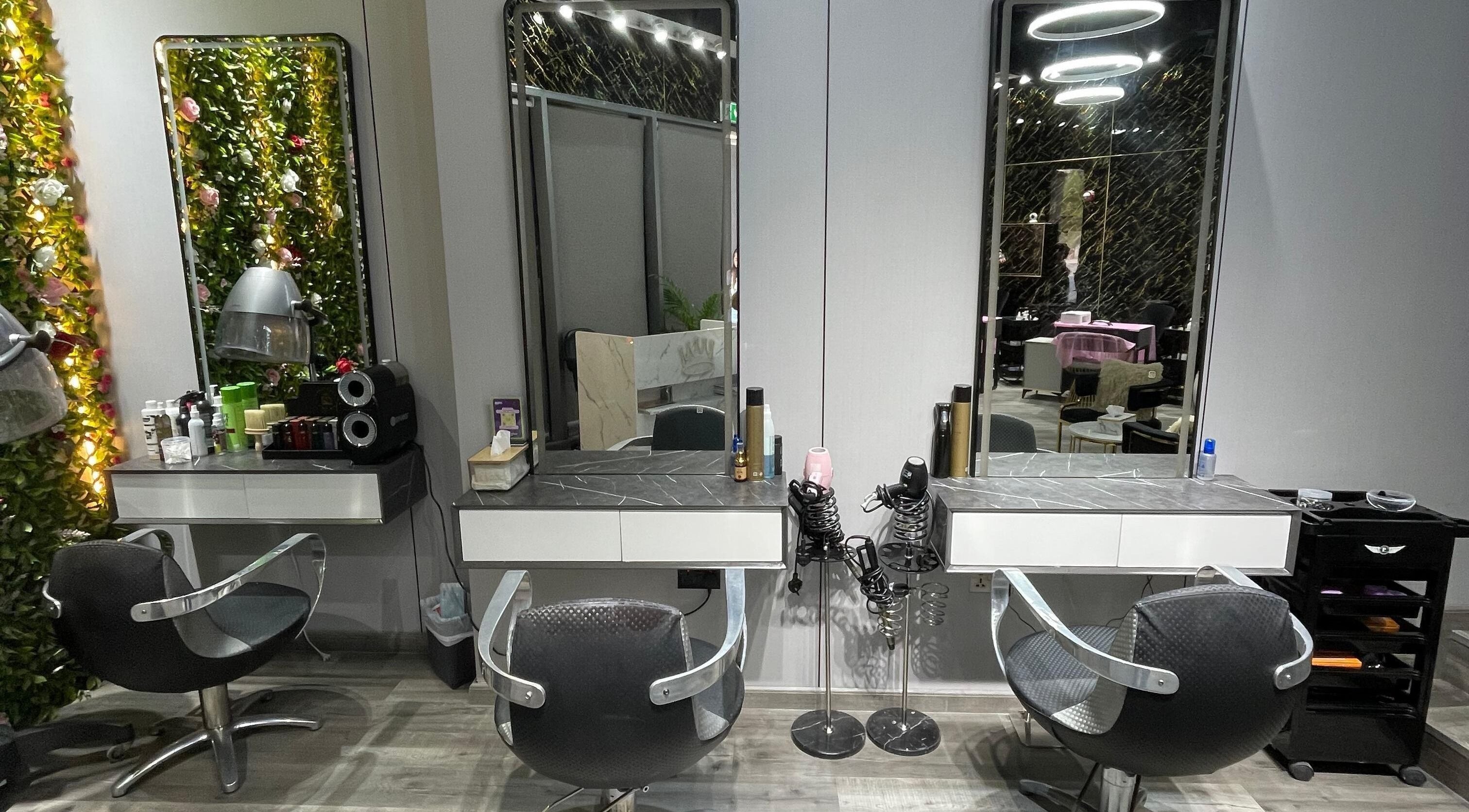 Modern styling stations at Bellaliza Beauty Salon L.L.C, Dubai, AE, featuring sleek chairs and illuminated mirrors.